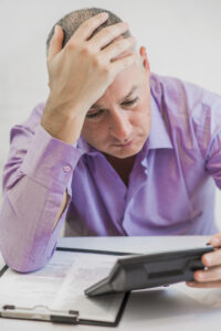 worried man with calculator